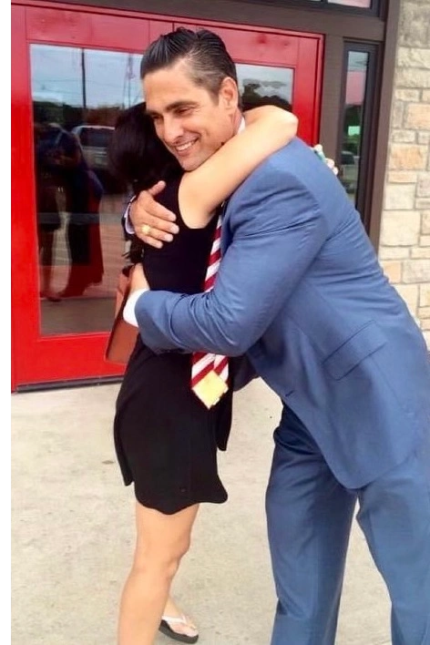 Sam Cammack III embracing a client after a favorable case outcome