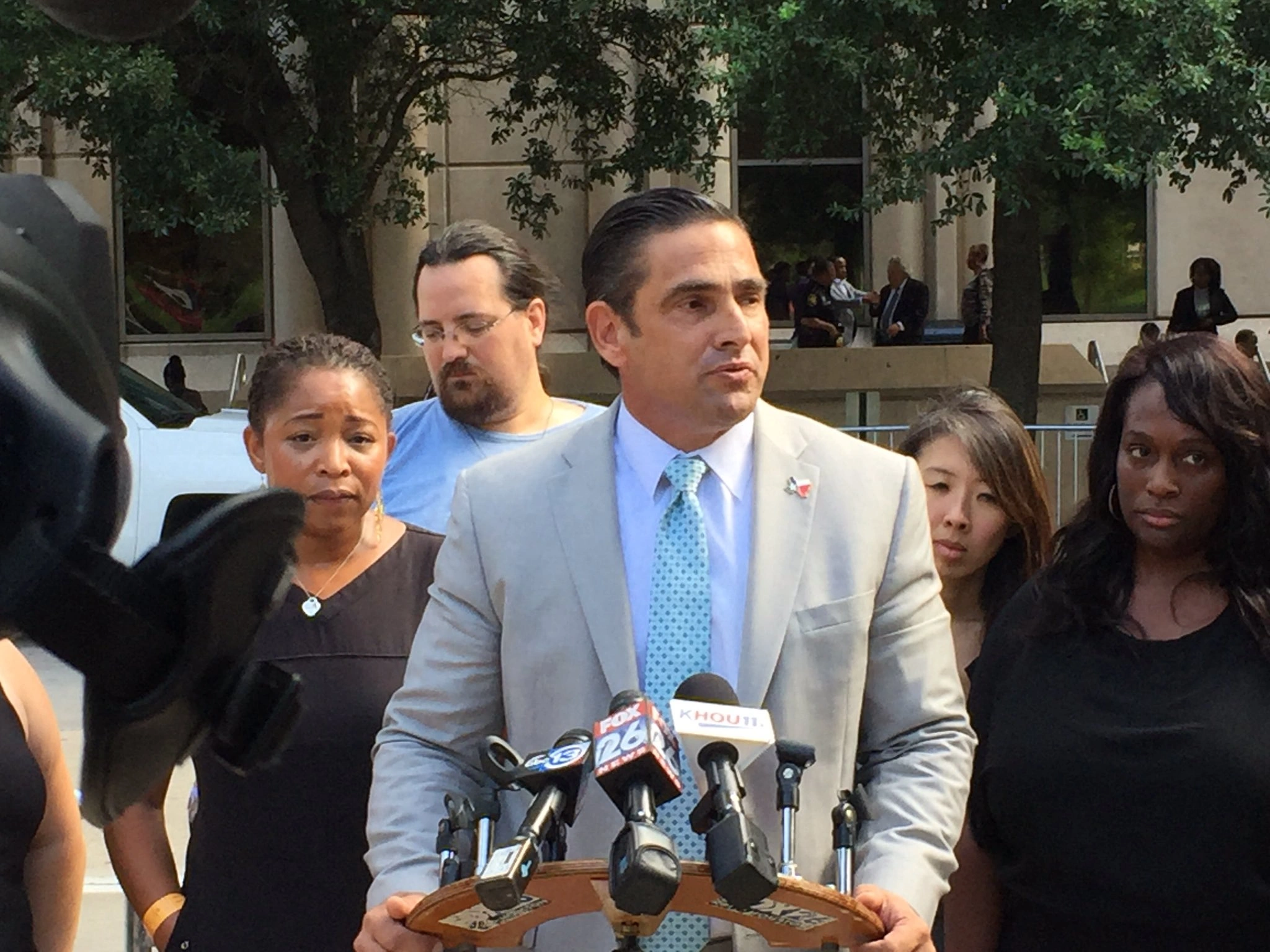 Sam Cammack III speaking to reporters outside the courthouse