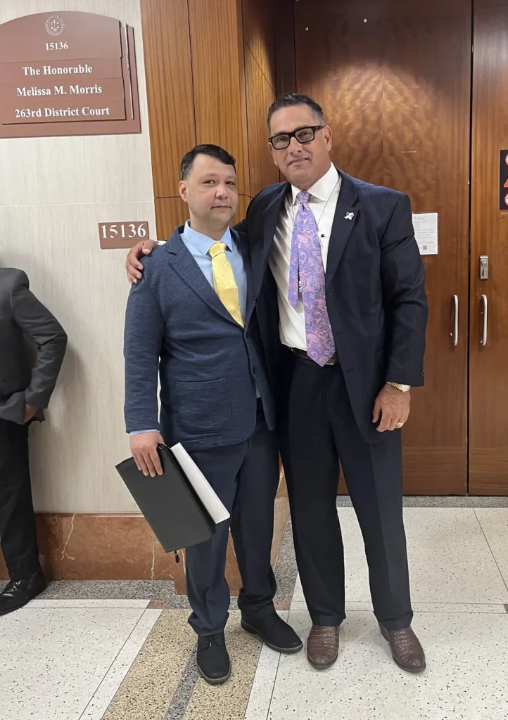 Sam R. Cammack III with a client outside the 263rd District Court after a family violence case involving an aggravated assault allegation